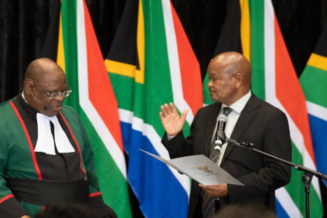 South Africa Chief Justice Raymond Zondo (L) swears in Senzo Mnchunu, as Minister of Police, in a sitting of the South African Parliament on Wednesday